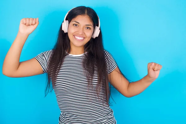 Smiling Carefree Young Hispanic Girl Wearing Striped Shirt Blue Background — Stock Photo, Image