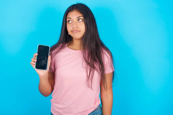 Joven Perpleja Hermosa Morena Hispana Camiseta Rosa Sobre Fondo Azul —  Fotos de Stock