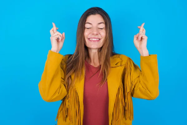 Joyful Woman Wearing Jacket Blue Studio Background Clenches Teeth Raises — Stock Photo, Image