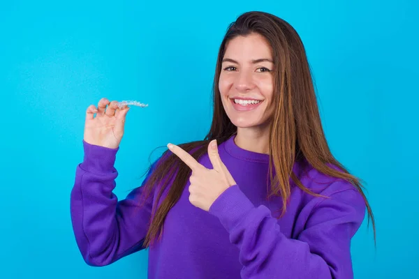 Beautiful Woman Wearing Purple Sweater Blue Studio Background Holding Invisible — Stock Photo, Image