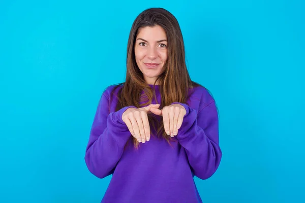Beautiful Woman Wearing Purple Sweater Blue Studio Background Makes Bunny — Stock Photo, Image
