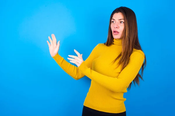Displeased Young Woman Wearing Yellow Turtleneck Sweater Keeping Hands Empty — Stock Photo, Image