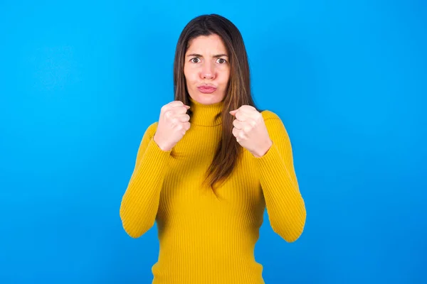 Displeased Annoyed Young Woman Wearing Yellow Turtleneck Sweater Clenches Fists — Stock Photo, Image