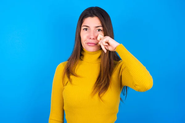 Disappointed Dejected Young Woman Wearing Yellow Turtleneck Sweater Wipes Tears — Stock Photo, Image
