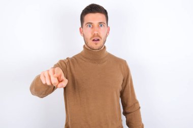 Şok olmuş genç beyaz adam, şaşkın bir ifadeyle seni işaret ediyor.