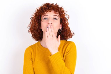 - Evet. Sanırım ben söyledim! Beyaz arka plan üzerine sarı kazak giyen genç, kızıl saçlı kızın portresini kapat. Avuç içlerini aç, büyük gözlerle kameraya bak..