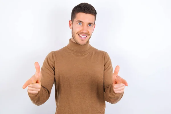 Young Caucasian Man Wearing Turtleneck White Background Directs Fingers Camera — Stock Photo, Image