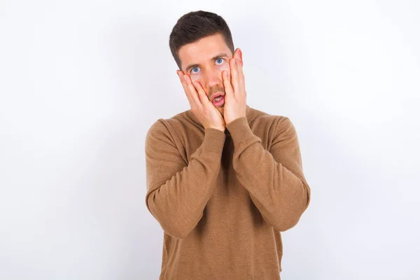Young Caucasian Man Keeps Hands Cheeks Has Bored Displeased Expression — Stock Photo, Image