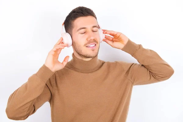Young Caucasian Man Wearing Turtleneck White Background Headphones Head Listens — Stock Photo, Image