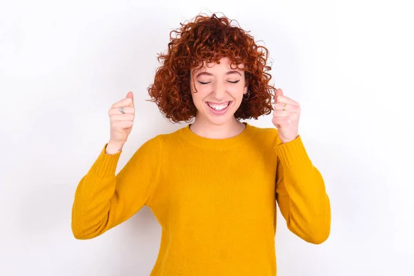 Young Redhead Girl Wearing Yellow Sweater White Background Rejoicing His — Stock Photo, Image