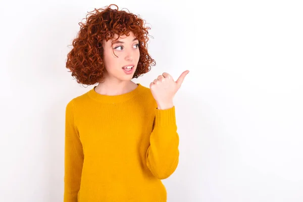 Stupefied Young Redhead Girl Wearing Yellow Sweater White Background Surprised — Stock Photo, Image