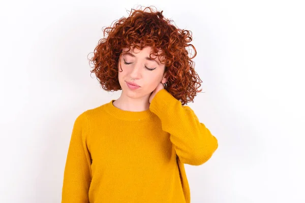 Young Redhead Girl Wearing Yellow Sweater White Background Suffering Back — Stock Photo, Image