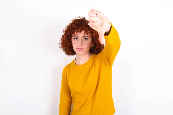 Discontent Young Redhead Girl Wearing Yellow Sweater White Background Shows — Stock Photo, Image
