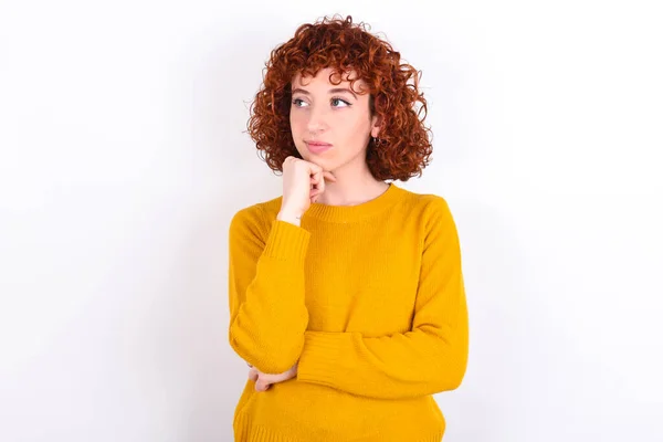 Young Redhead Girl Wearing Yellow Sweater White Background Hand Chin — Stock Photo, Image