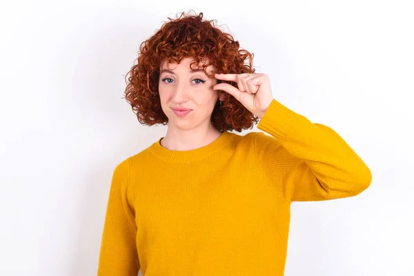 Upset Young Redhead Girl Wearing Yellow Sweater White Background Shapes — Stock Photo, Image