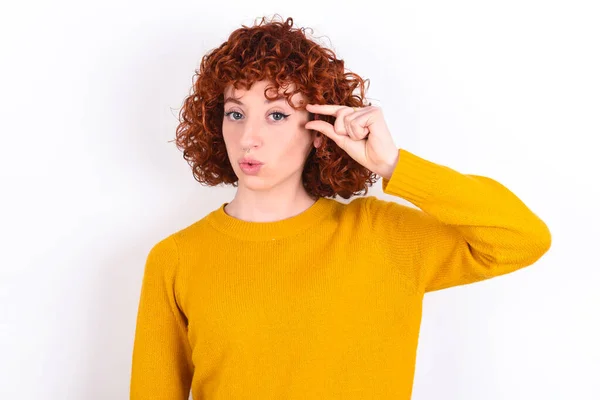 Shocked Young Redhead Girl Wearing Yellow Sweater White Background Shows — Stock Photo, Image