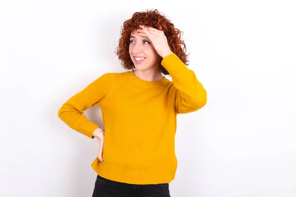 Young Redhead Girl Wearing Yellow Sweater White Background Touching Forehead — Stock Photo, Image