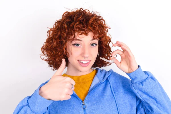 Young Redhead Girl Wearing Blue Jacket White Background Holding Invisible — Stock Photo, Image