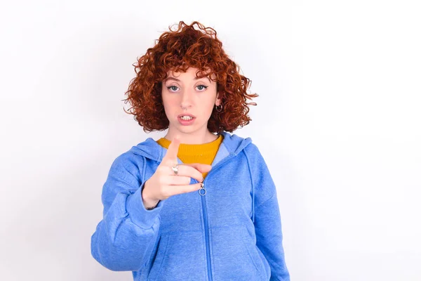 Shocked Young Redhead Girl Wearing Blue Jacket White Background Points — Stock Photo, Image