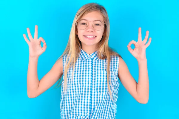 Glad Little Caucasian Kid Girl Shows Sign Both Hands Expresses — Stock Photo, Image