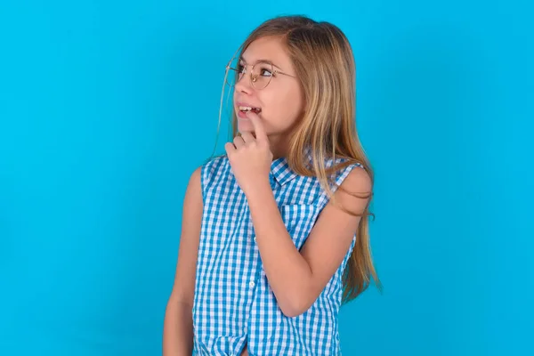 Little Caucasian Kid Girl Thoughtful Expression Looks Camera Keeps Hand — Stock Photo, Image