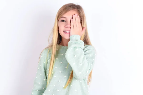 girl  covering one eye with her hand, confident smile on face and surprise emotion.