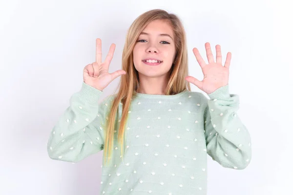 小さな白人少女は自信と幸せに微笑んでいる間指番号8を示し 指を指さす — ストック写真
