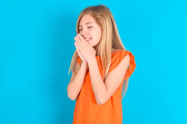 Overjoyed Little Kid Girl Wearing Orange Shirt Blue Background Laughs — Stock Photo, Image