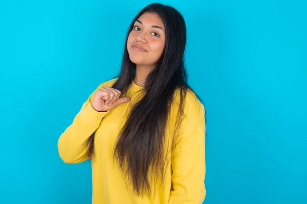 Closeup Cheerful Latin Woman Wearing Yellow Sweatshirt Blue Background Looks — Stock Photo, Image