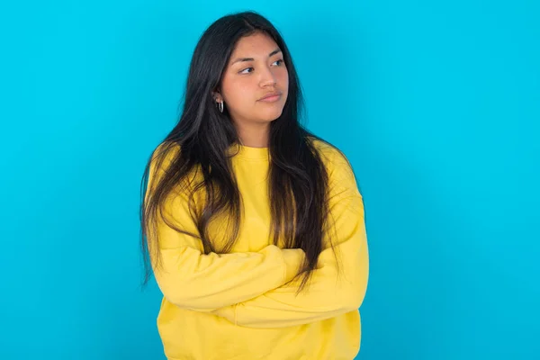 Image Upset Latin Woman Wearing Yellow Sweatshirt Blue Background Arms — Stock Photo, Image