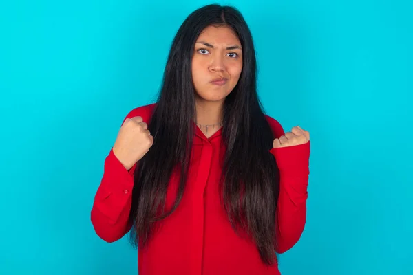 Irritated Latin Woman Wearing Red Shirt Blue Background Blows Cheeks — Stock Photo, Image