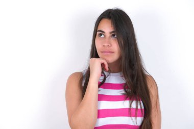 Beyaz duvarın üzerinde çizgili bluz giyen güzel esmer kadının portresi elini çenesinin altında tutuyor, bir şey hatırlamaya çalışıyor ya da ilgi çekici bir şey dinliyor. Gençlik kavramı.