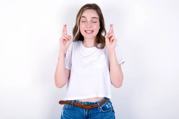 Joyful Girl Clenches Teeth Raises Fingers Crossed Makes Desirable Wish — Stock Photo, Image