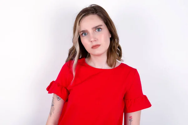 Displeased Young Caucasian Woman Wearing Red Shirt White Background Frowns — Stock Photo, Image