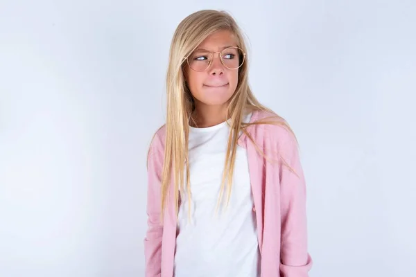 Beyaz Arka Plan Üzerinde Pembe Ceketli Gözlüklü Küçük Sarışın Kız — Stok fotoğraf