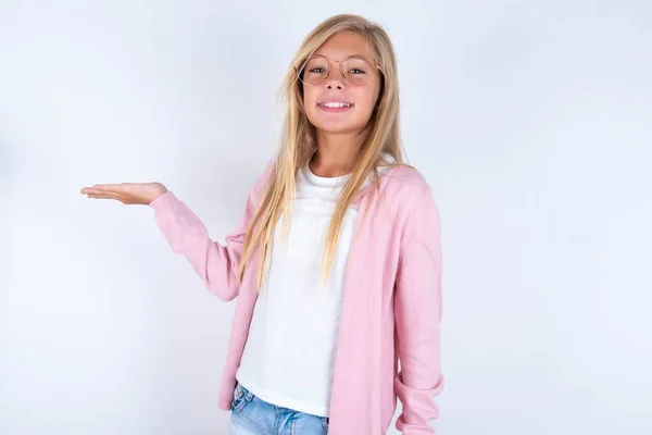 Blonde Little Girl Wearing Pink Jacket Glasses White Background Pointing — Stock Photo, Image
