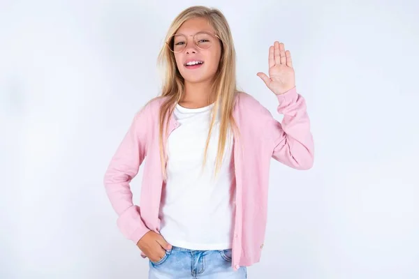 Menina Loira Vestindo Jaqueta Rosa Óculos Sobre Fundo Branco Waiving — Fotografia de Stock