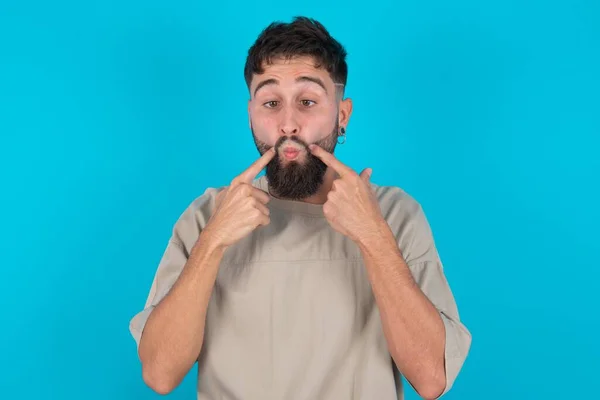 Bearded Caucasian Man Wearing Casual Shirt Blue Background Crosses Eyes — Stock Photo, Image