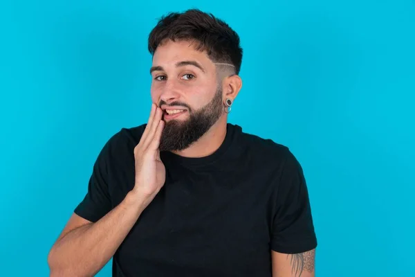 Jovem Hispânico Barbudo Vestindo Camiseta Preta Contra Fundo Azul Tocando — Fotografia de Stock