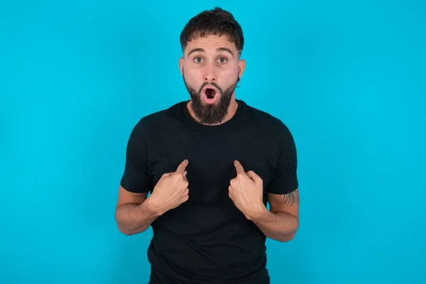 Embarrassed Hispanic Bearded Man Wearing Black Shirt Standing Blue Background — Stock Photo, Image