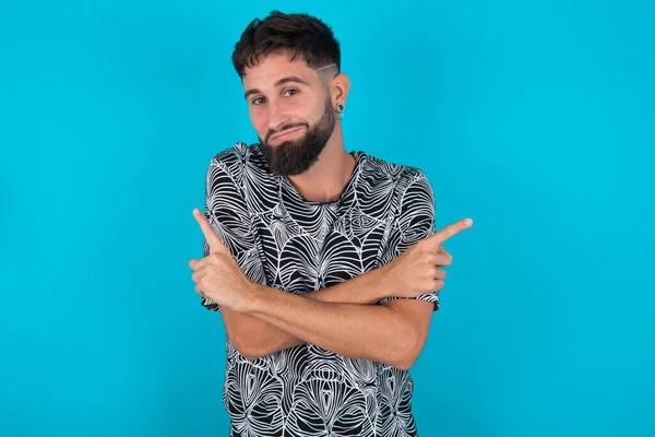 Young Hispanic Bearded Man Standing Blue Background Crosses Arms Points — Stock Photo, Image