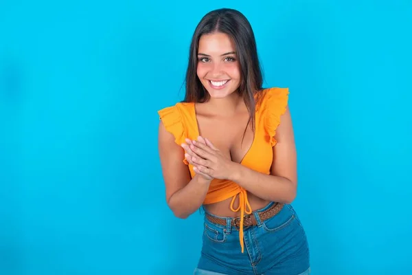 Beautiful Brunette Woman Wearing Orange Tank Top Blue Background Feeling — Stock Photo, Image