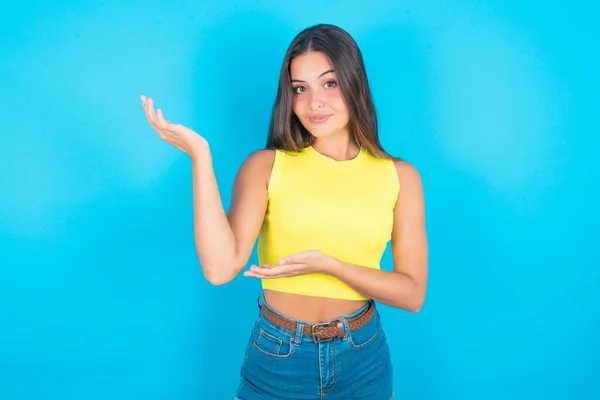 Beautiful Brunette Woman Wearing Yellow Tank Top Blue Background Pointing — Stock Photo, Image