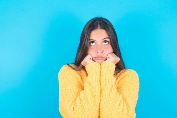 Portrait Sad Young Brunette Woman Wearing Yellow Sweater Blue Background — Stock Photo, Image