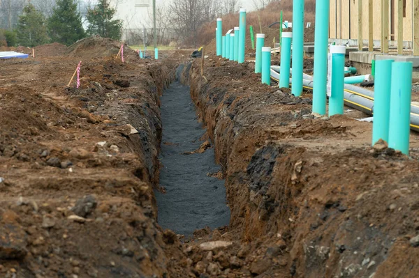 Laying of cables and pipes in the trench water — Stock Photo, Image