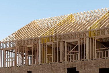 frame and rafters of a house under construction timber plank wall