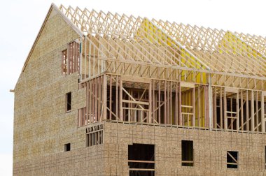 frame and rafters of a new plywood house roof framework