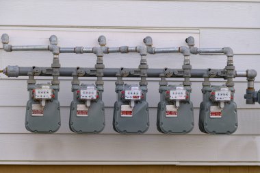 Digital electric meters in a row measuring power use wall power voltagesupply
