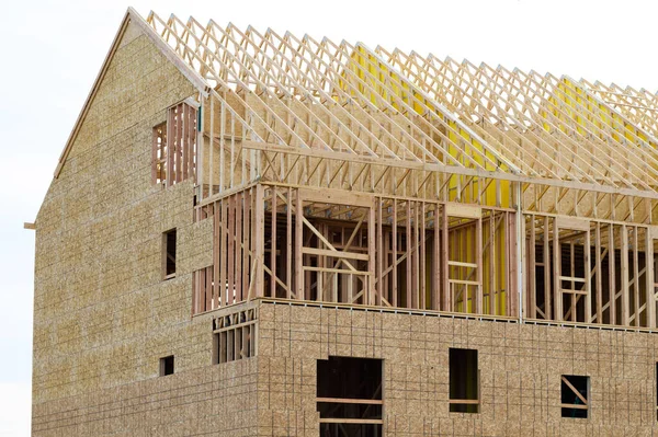 frame and rafters of a new plywood house roof framework
