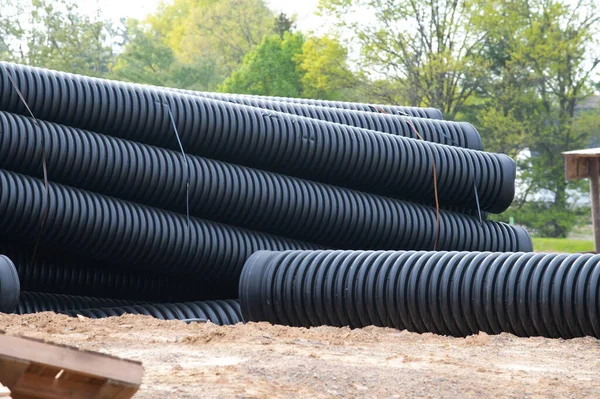 Large Black Plastic Sewer Pipes Lie Water System — стоковое фото